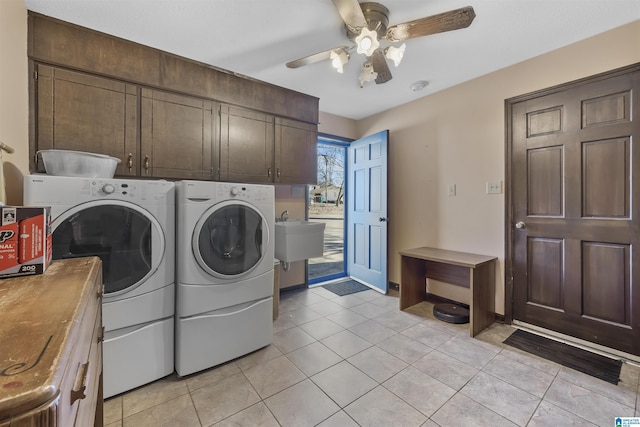 washroom with light tile patterned floors, ceiling fan, separate washer and dryer, and cabinet space