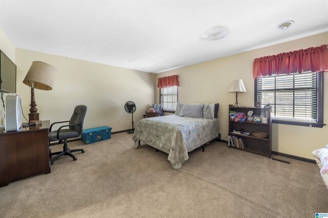 carpeted bedroom with baseboards