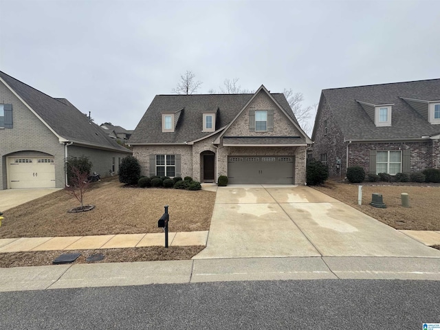 view of front of house featuring a garage, driveway, brick siding, and a shingled roof