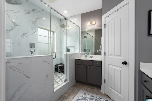 bathroom featuring vanity and a marble finish shower