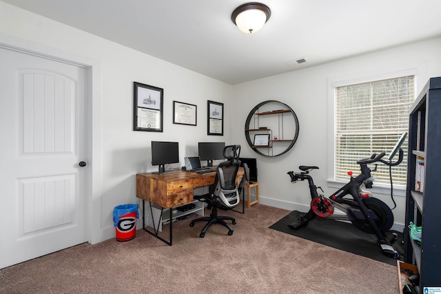 carpeted office with visible vents and baseboards