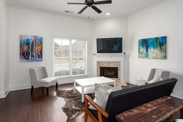 living area featuring a fireplace, wood-type flooring, visible vents, ornamental molding, and baseboards