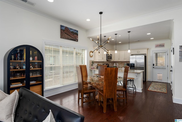 dining space with baseboards, visible vents, dark wood finished floors, crown molding, and recessed lighting