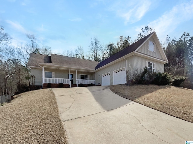 view of front facade featuring a porch, an attached garage, and concrete driveway