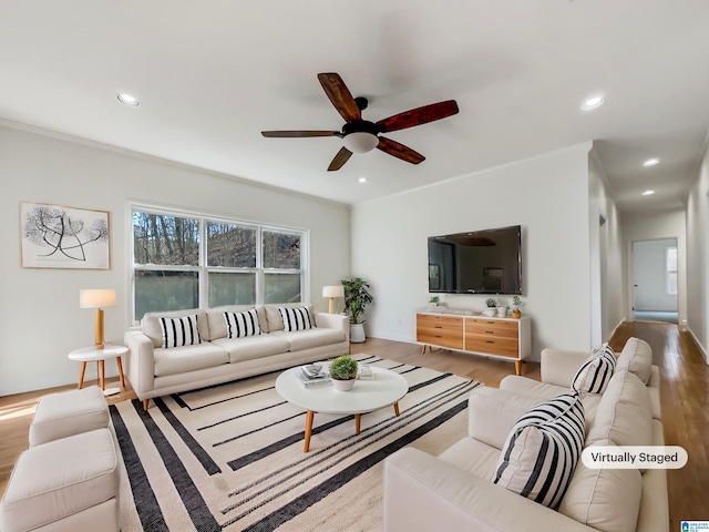 living room featuring baseboards, recessed lighting, a ceiling fan, and light wood finished floors