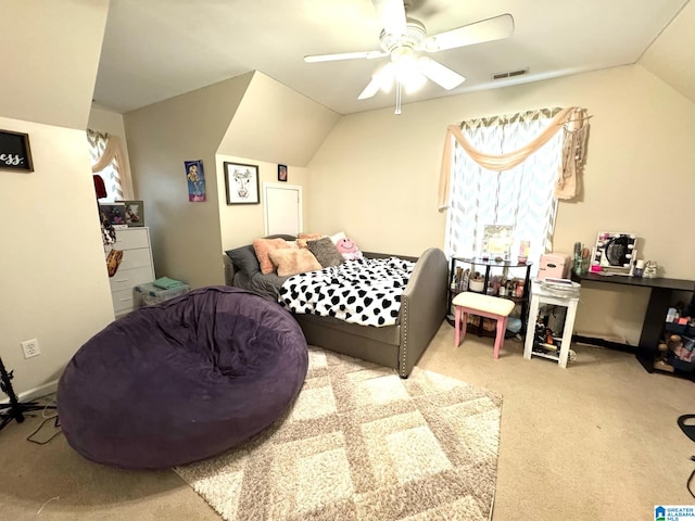 carpeted bedroom featuring lofted ceiling, ceiling fan, visible vents, and baseboards