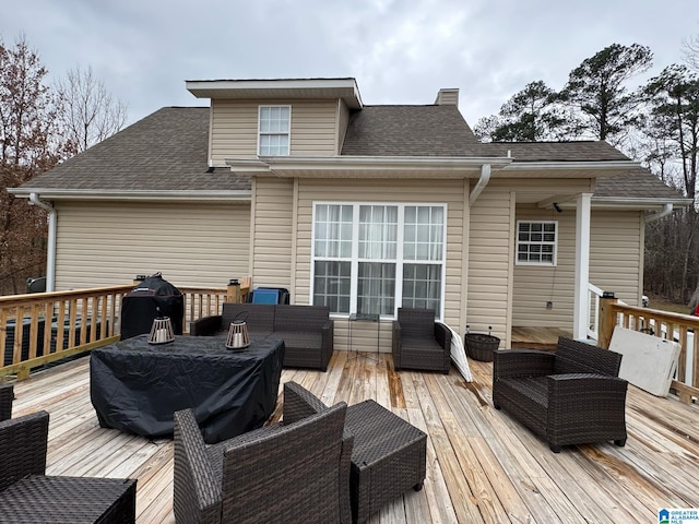 wooden deck with a grill and an outdoor living space