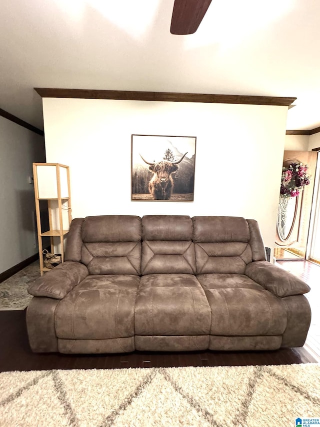 living area with ceiling fan, baseboards, wood finished floors, and crown molding