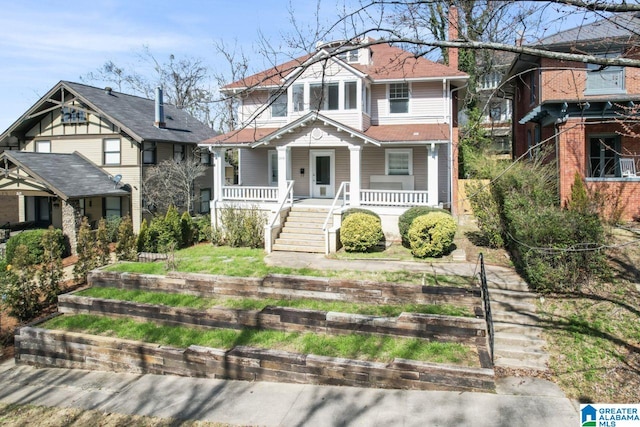 view of front of home with a residential view, covered porch, and stairway