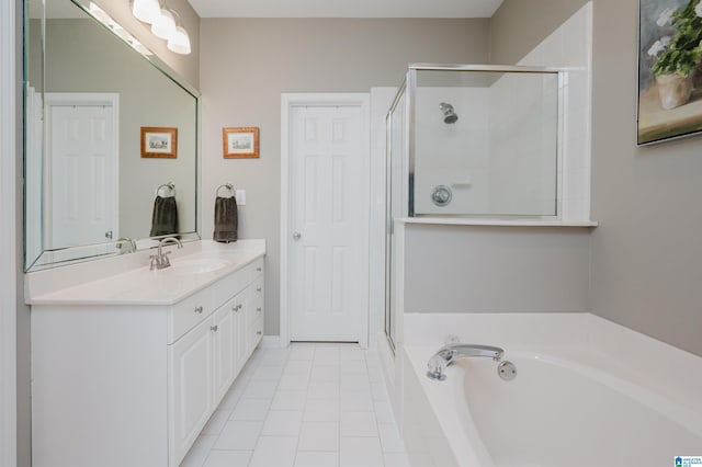 full bathroom with a stall shower, tile patterned flooring, a garden tub, and vanity