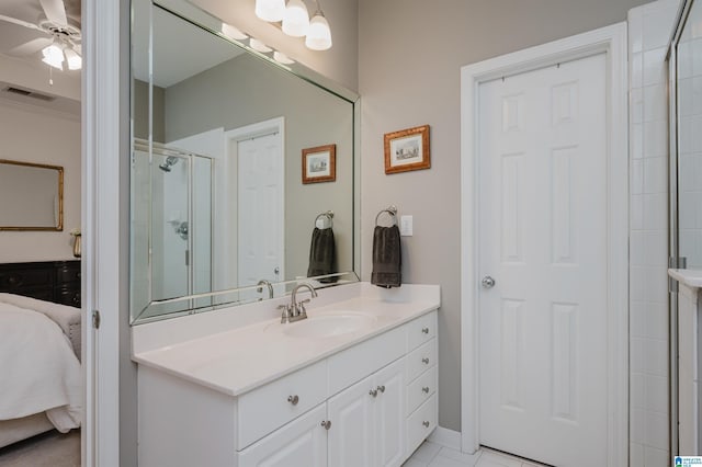 ensuite bathroom featuring visible vents, ensuite bathroom, a ceiling fan, a stall shower, and vanity