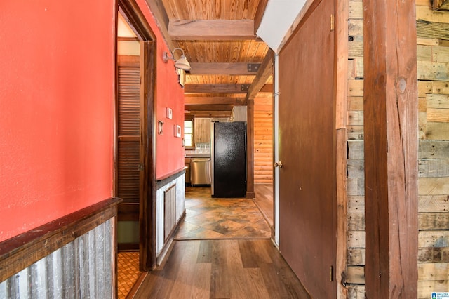 hall with arched walkways, beamed ceiling, wooden ceiling, and wood finished floors