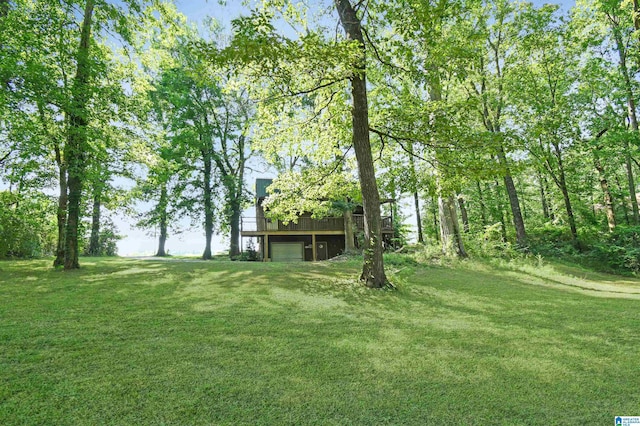 view of yard featuring a garage and a deck