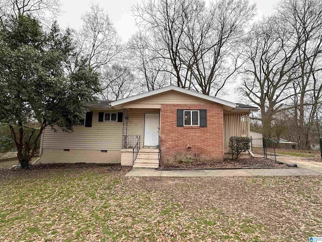 view of front facade featuring crawl space and brick siding