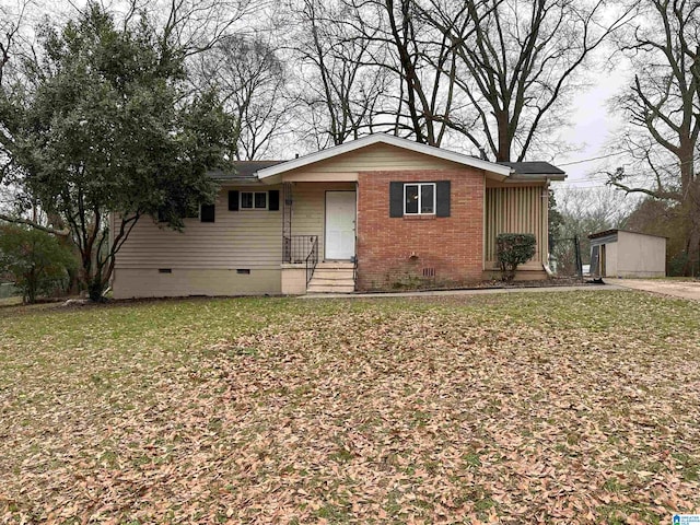 view of front of home featuring a front lawn, crawl space, and brick siding