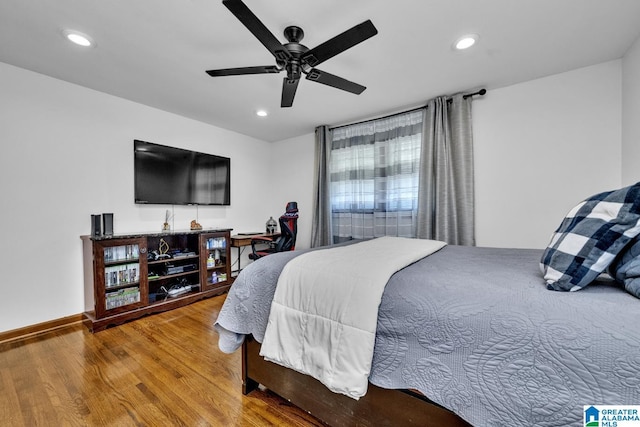 bedroom featuring ceiling fan, baseboards, wood finished floors, and recessed lighting