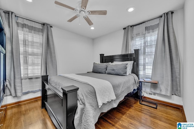 bedroom featuring wood finished floors, a ceiling fan, and recessed lighting