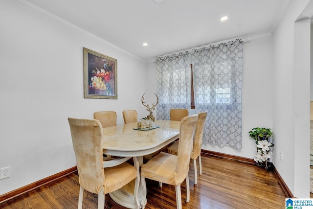 dining space with baseboards, ornamental molding, wood finished floors, and recessed lighting