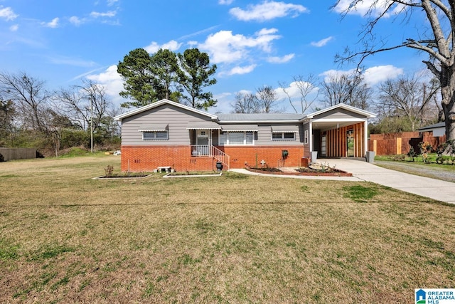 ranch-style house with a carport, driveway, brick siding, and a front yard