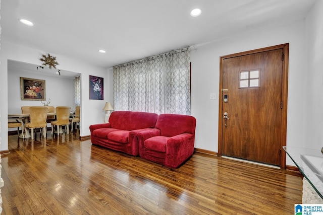 living room with recessed lighting, baseboards, and wood finished floors