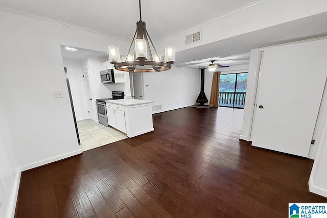 kitchen featuring visible vents, white cabinetry, hanging light fixtures, appliances with stainless steel finishes, and light wood finished floors