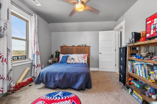 bedroom featuring carpet floors, a ceiling fan, and lofted ceiling