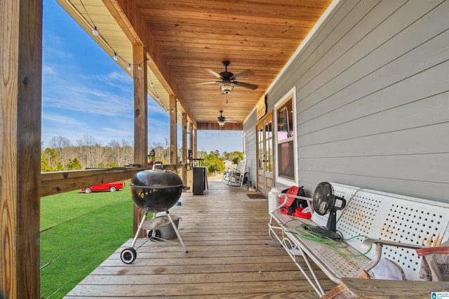 wooden deck with a porch and a ceiling fan