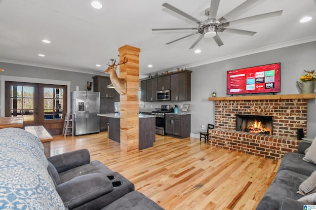 living room with light wood-type flooring, ornamental molding, and french doors