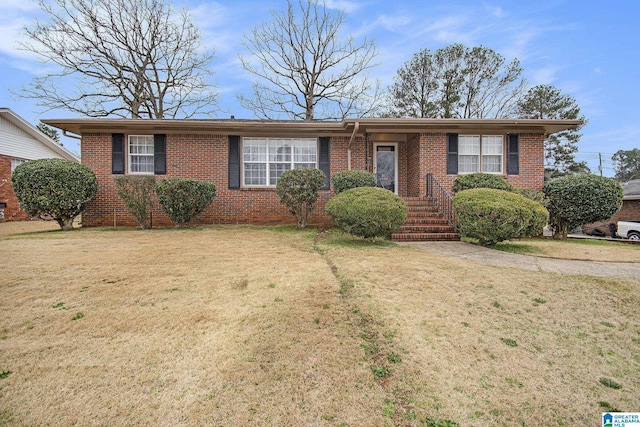 ranch-style house with a front lawn and brick siding