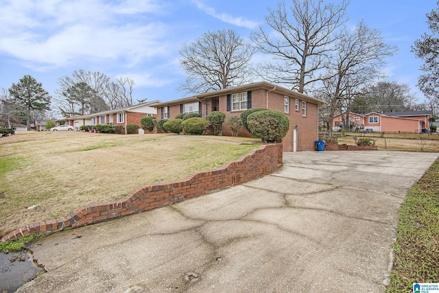 ranch-style house with a residential view, a front lawn, and brick siding