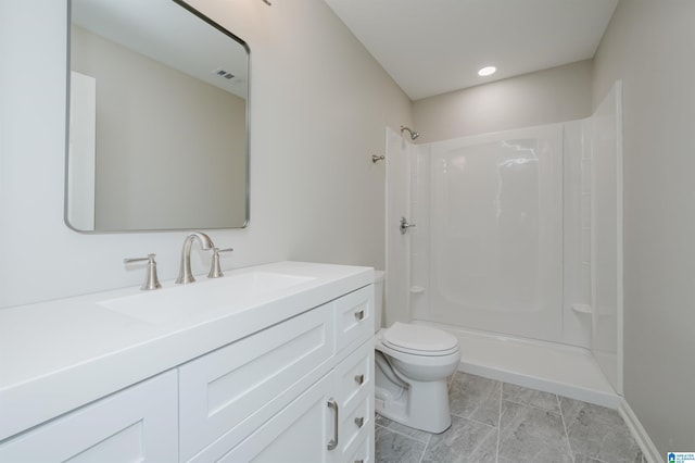 bathroom with a shower, visible vents, vanity, and toilet