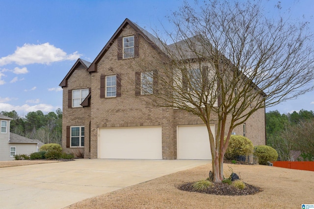 view of front of home with concrete driveway, brick siding, and an attached garage