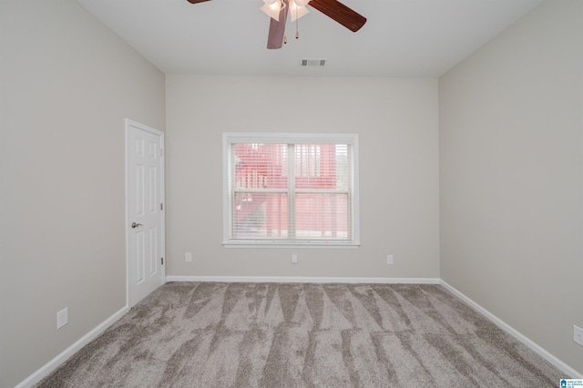 unfurnished room with ceiling fan, carpet flooring, visible vents, and baseboards