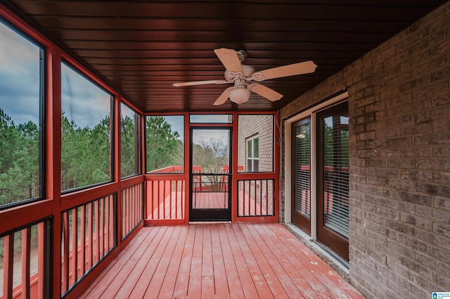 unfurnished sunroom with a ceiling fan