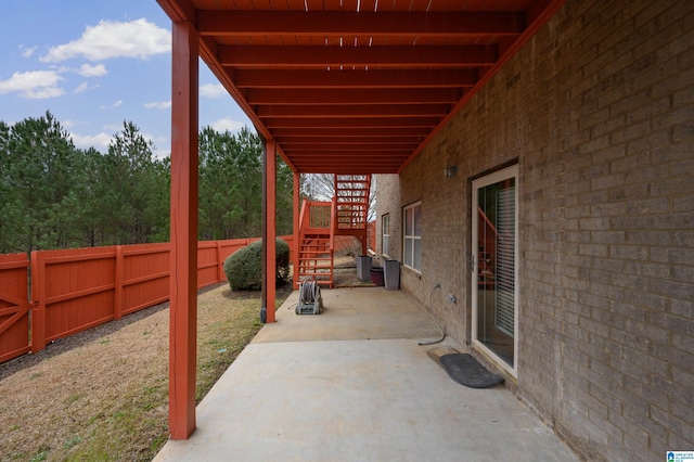 view of patio / terrace featuring stairs and a fenced backyard