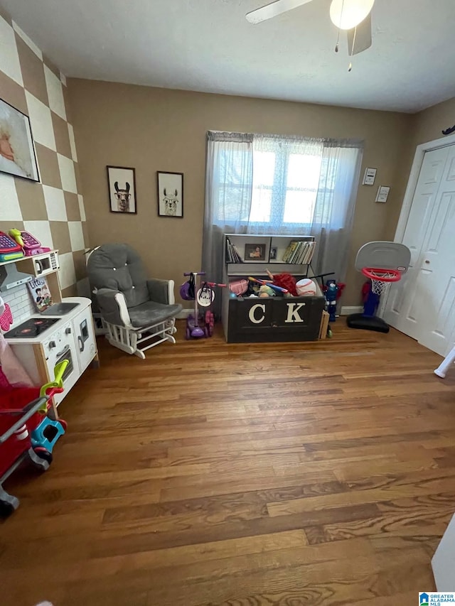 playroom featuring a ceiling fan and wood finished floors