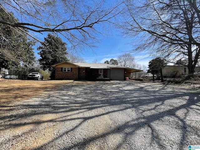 exterior space featuring metal roof and driveway