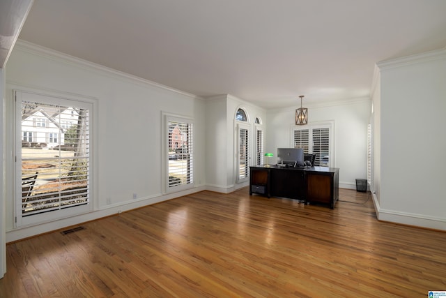 unfurnished office with ornamental molding, visible vents, and wood finished floors