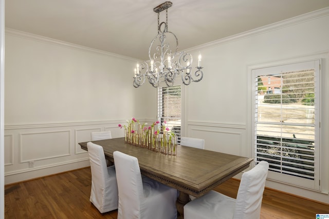 dining space featuring a wainscoted wall, crown molding, and wood finished floors