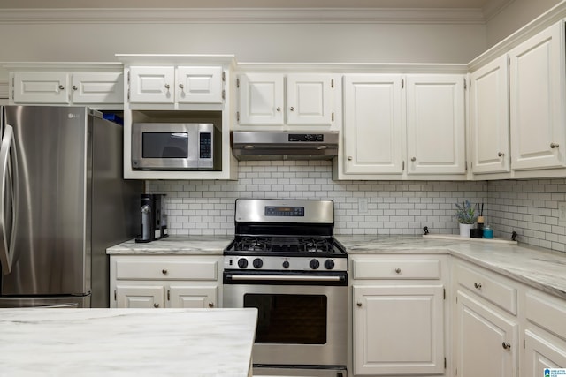 kitchen with appliances with stainless steel finishes, white cabinets, crown molding, and ventilation hood