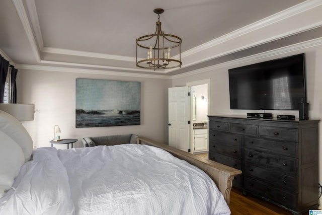 bedroom with ensuite bathroom, a notable chandelier, dark wood-style floors, a raised ceiling, and crown molding