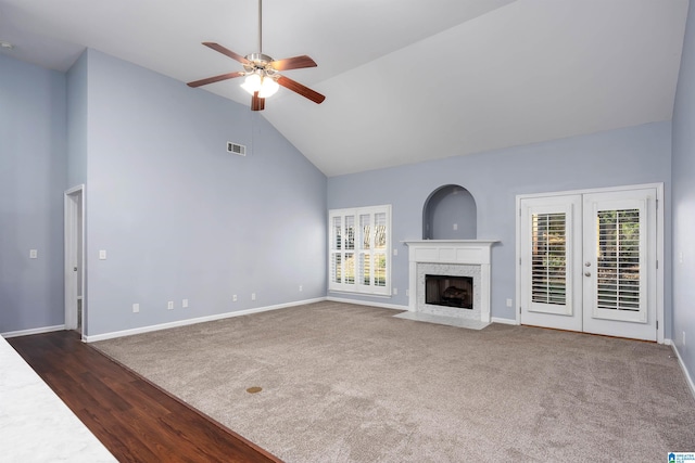 unfurnished living room featuring plenty of natural light, a fireplace, visible vents, and baseboards