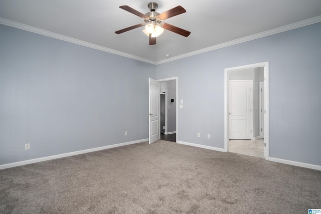 unfurnished bedroom with baseboards, ornamental molding, and light colored carpet