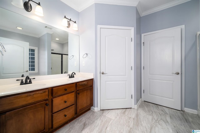 full bathroom featuring crown molding, a sink, and a shower stall