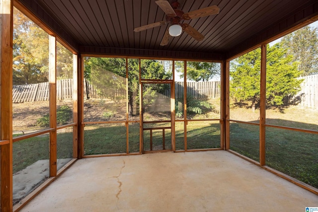 unfurnished sunroom with a ceiling fan