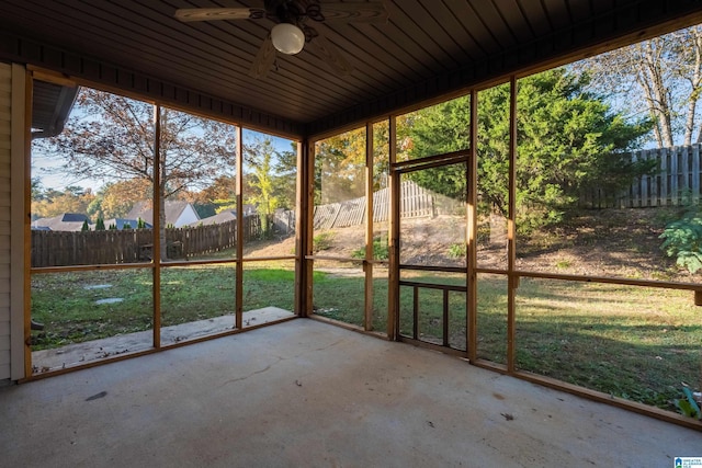 unfurnished sunroom featuring a ceiling fan