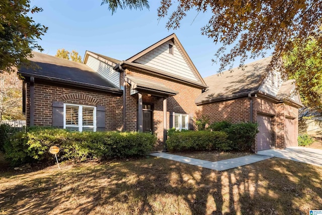 view of front facade featuring an attached garage, concrete driveway, and brick siding