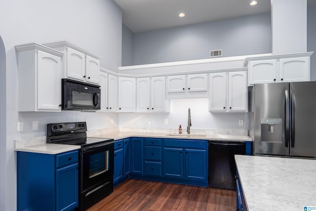 kitchen featuring a sink, black appliances, light countertops, and blue cabinets