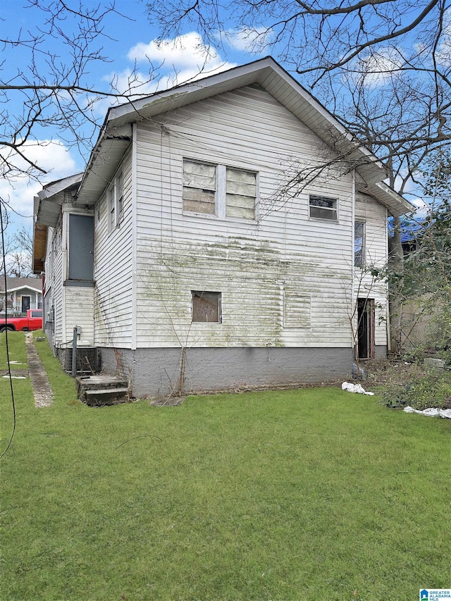 view of property exterior featuring a lawn and cooling unit