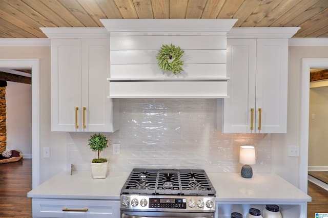 kitchen with light countertops, ornamental molding, gas stove, and white cabinetry